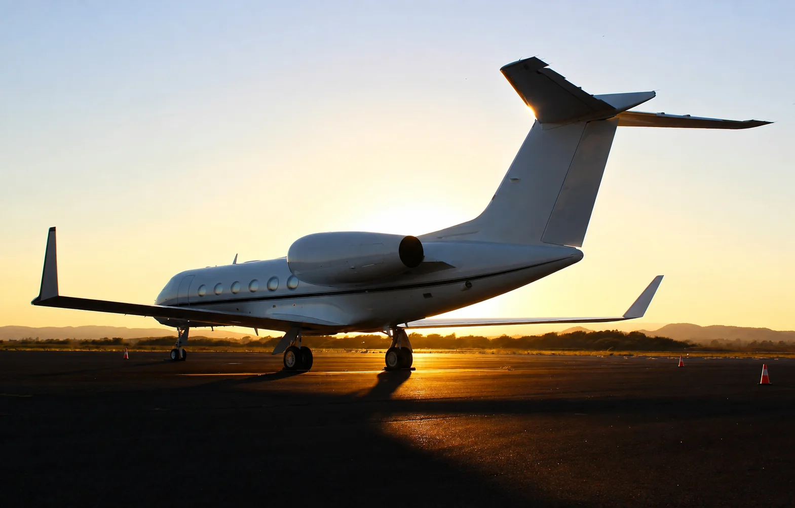 Private jet on the ramp at sunset