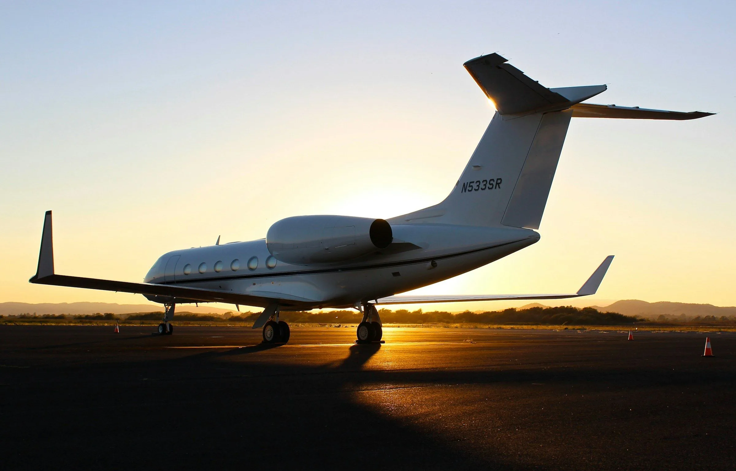 Private jet on the ramp at sunset
